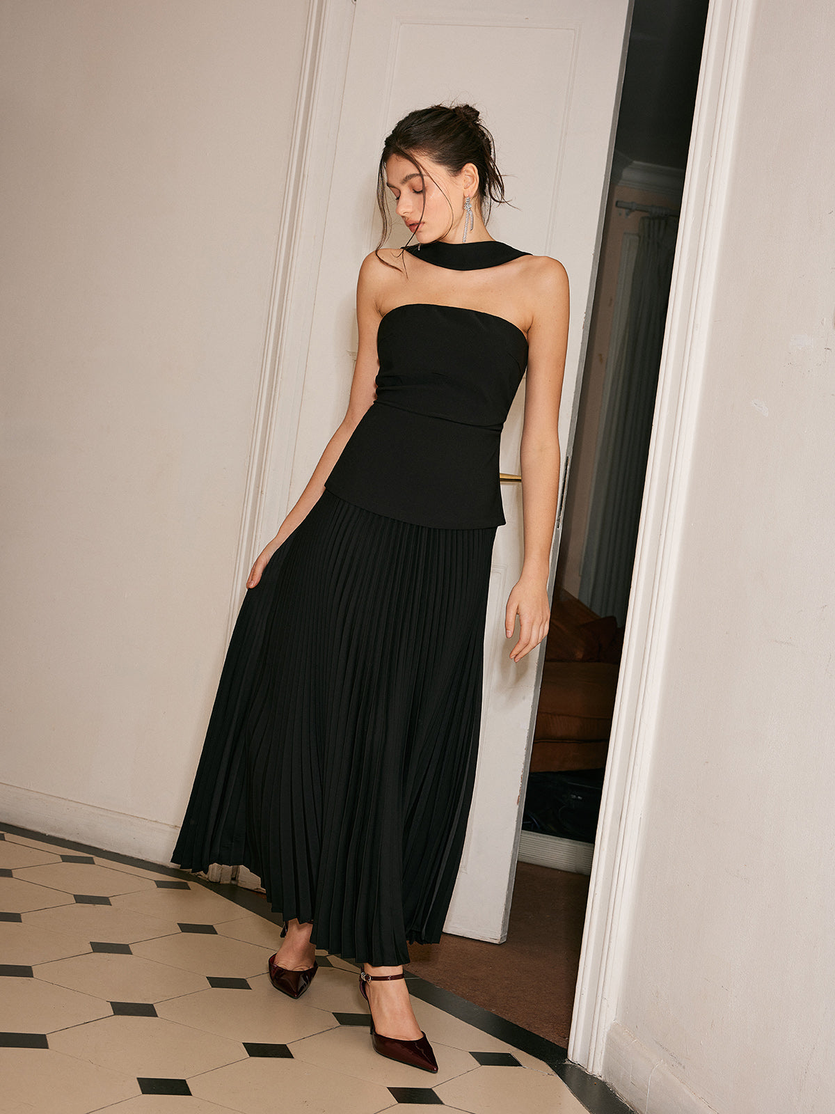A choker neck dress featuring pleated front detail from LA FINE FLEUR, elegant and refined.
