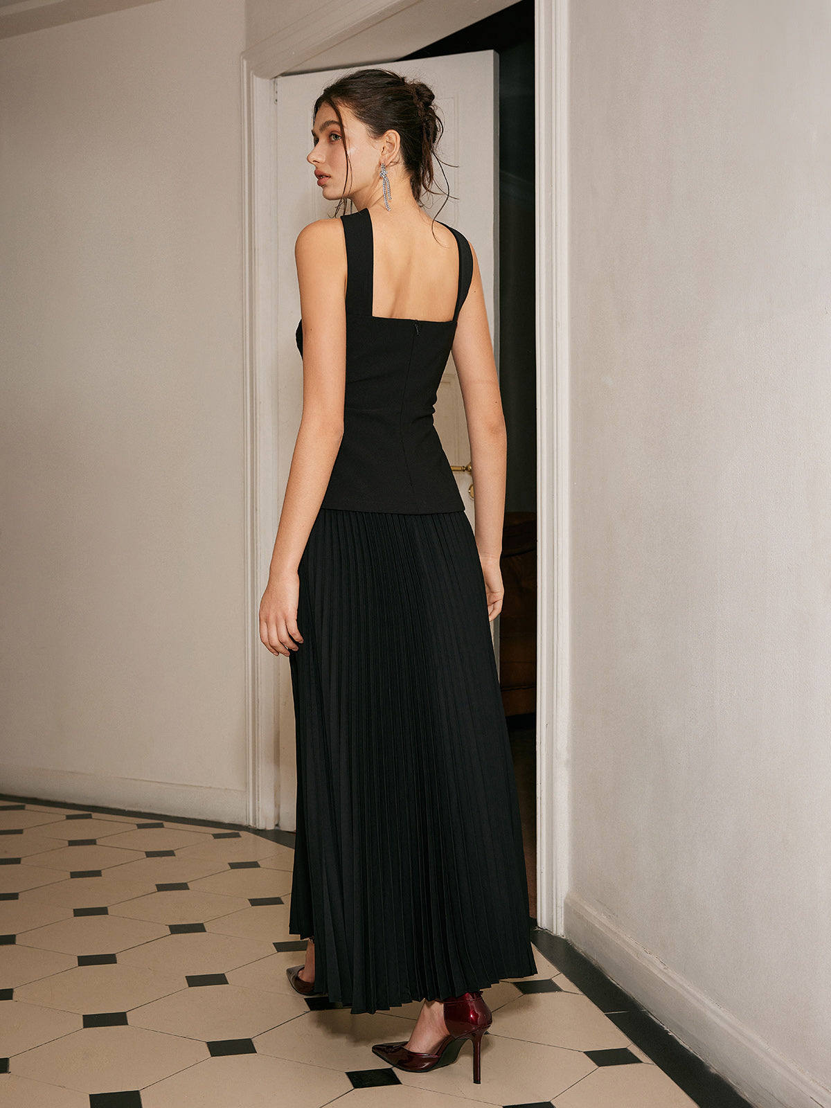 A choker neck dress with pleated front detail in a smooth, elegant fabric.