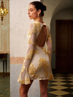 Elegant floral mesh dress with a backless design, showcasing intricate detailing and fine tailoring.