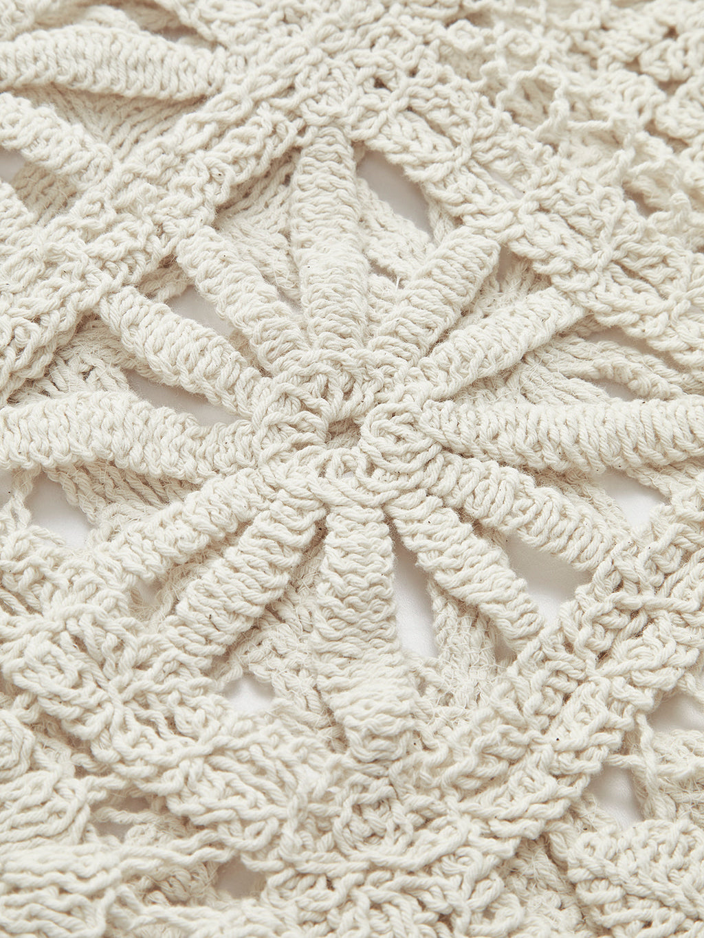 Beige crocheted sweater with intricate square pattern, textured yarn, and delicate openwork detailing.