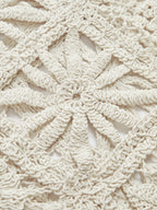 Beige crocheted sweater with intricate square pattern, textured yarn, and delicate openwork detailing.