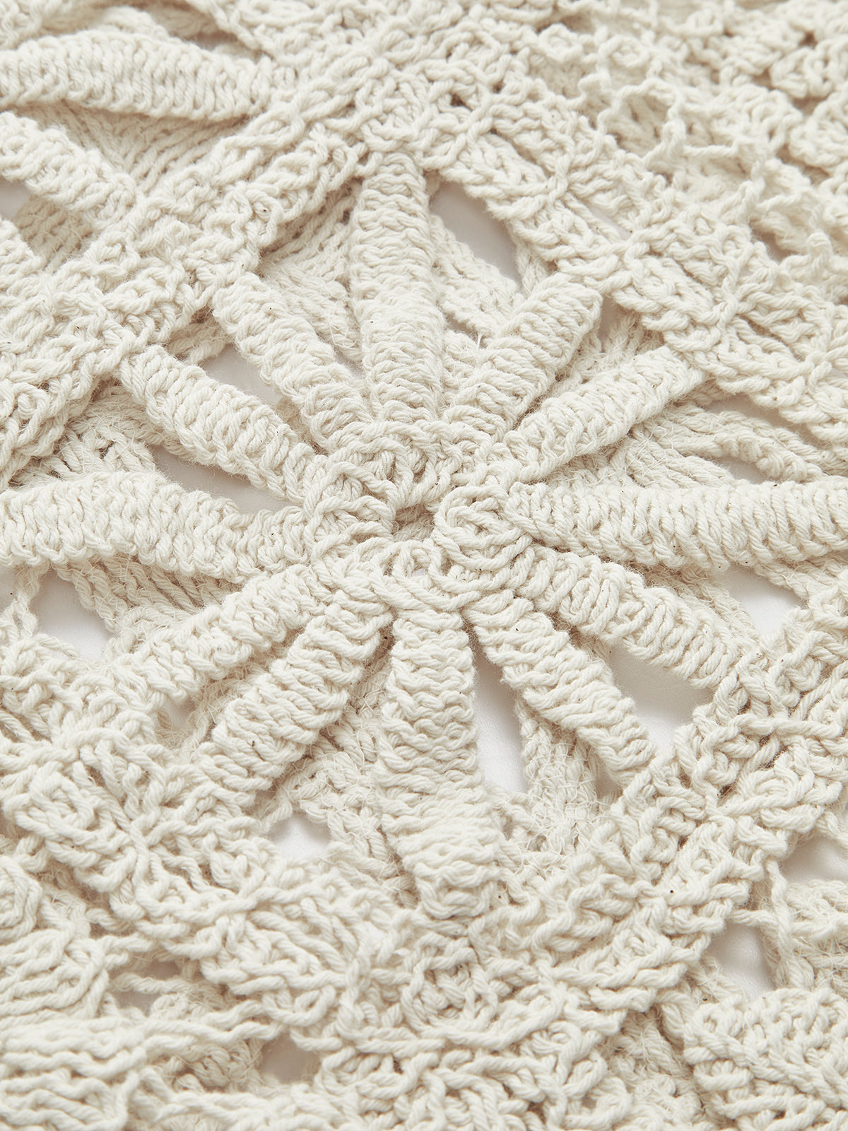 Beige crocheted sweater with intricate square pattern, textured yarn, and delicate openwork detailing.