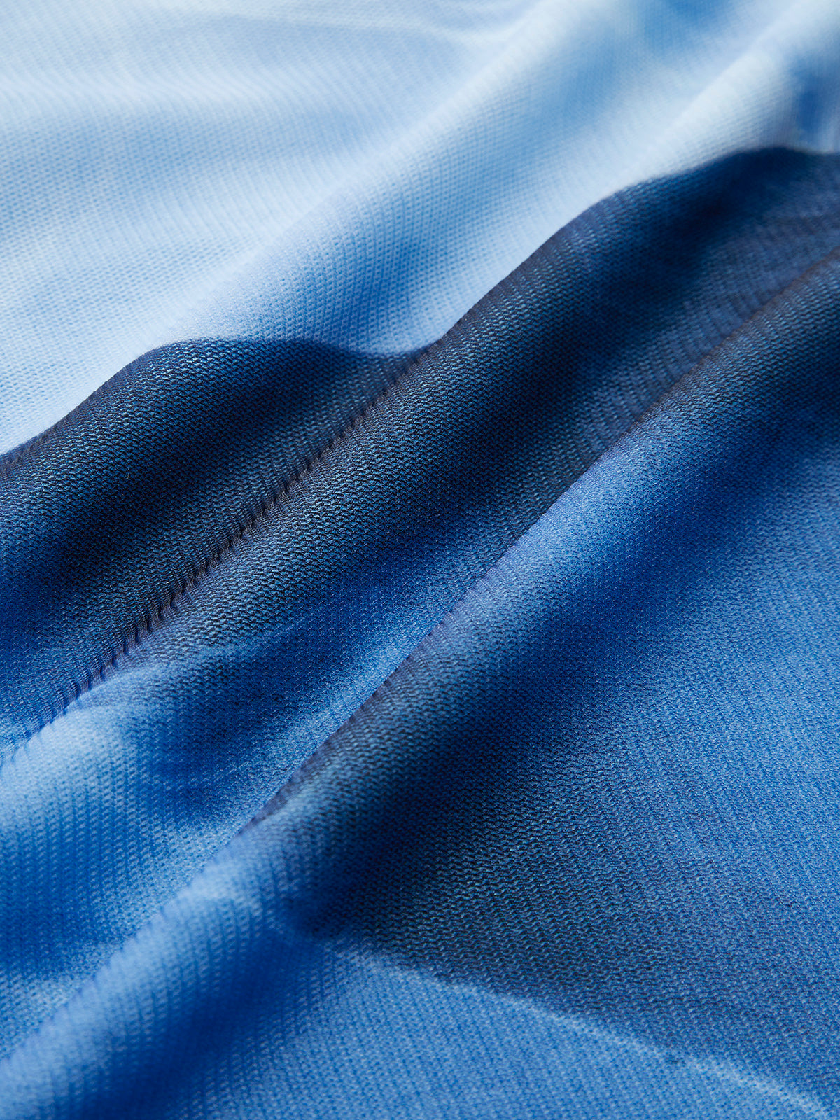 Sleeveless dress made of blue gradient fabric with a soft, airy, and elegant texture.