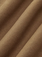 Close-up of brown ribbed knit sweatshirt sweater with wavy folds accentuating fine texture.
