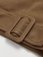 Oversized brown cinched-waist sweatshirt sweater with sewn-on belt featuring a rectangular buckle.