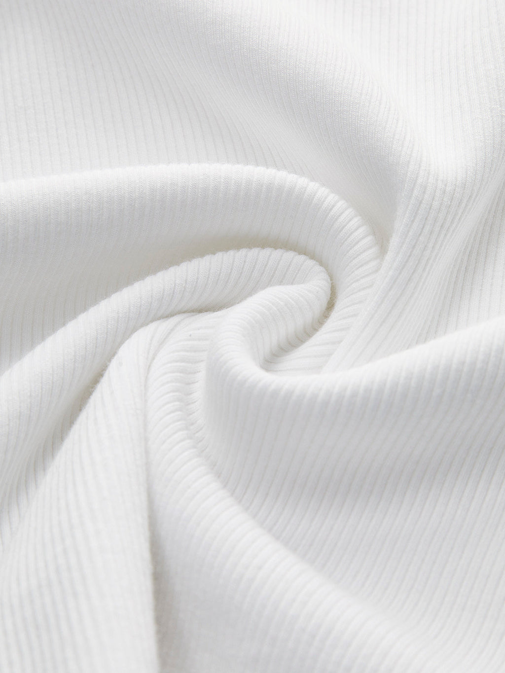 White ribbed sleeveless crop top with soft spiral folds and subtle textured lines.