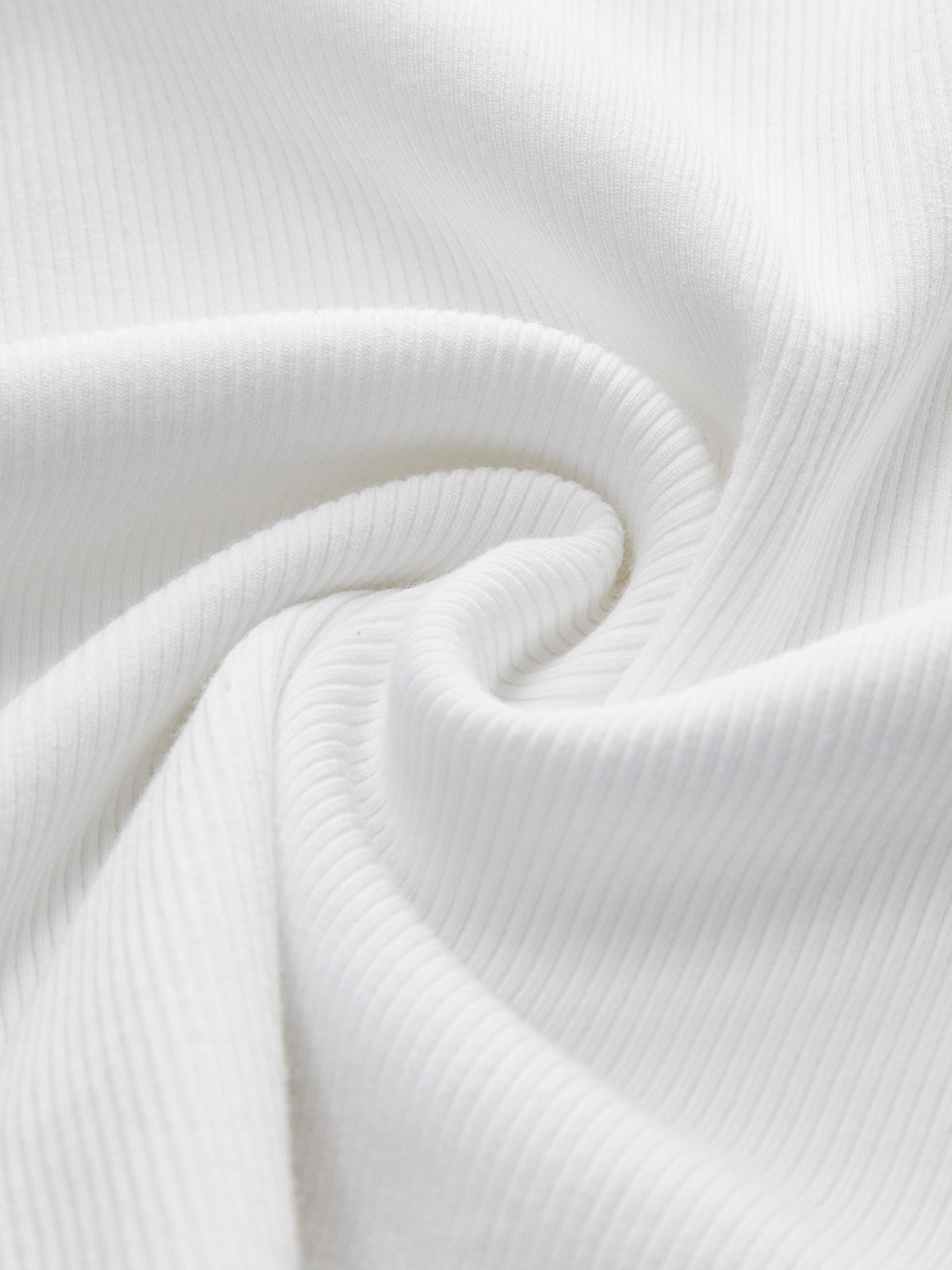 White ribbed sleeveless crop top with soft spiral folds and subtle textured lines.