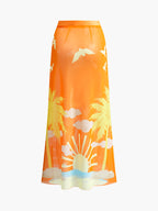 Vibrant tropical floral sarong skirt featuring palm trees, birds, clouds, and sunrise print.