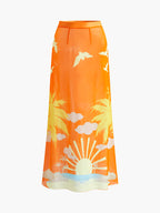 A vibrant orange sarong skirt with yellow palm trees, sun, waves, clouds, and birds.