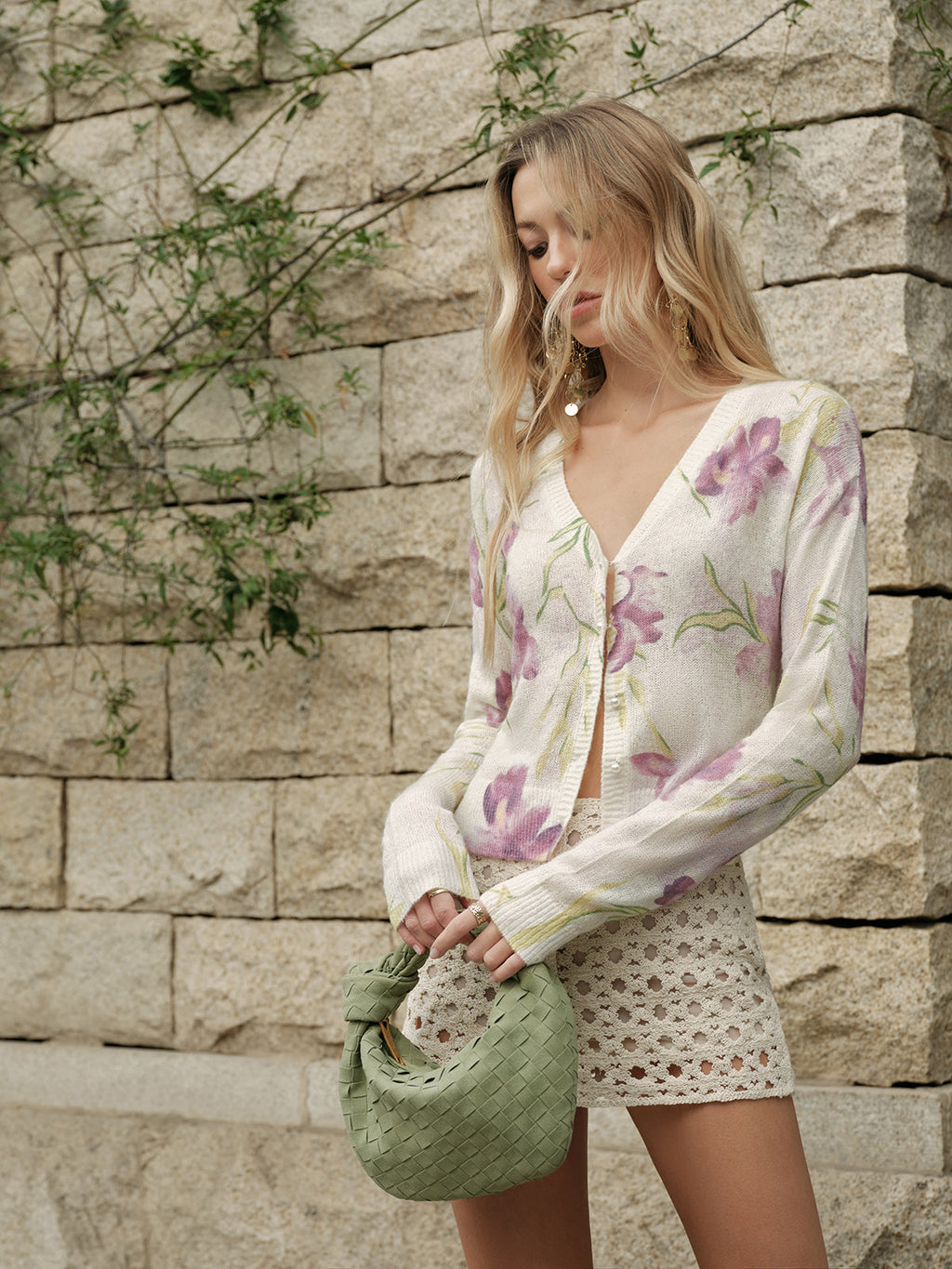 Floral wool-blend knit cardigan with cozy patterns, paired with cream crochet shorts.