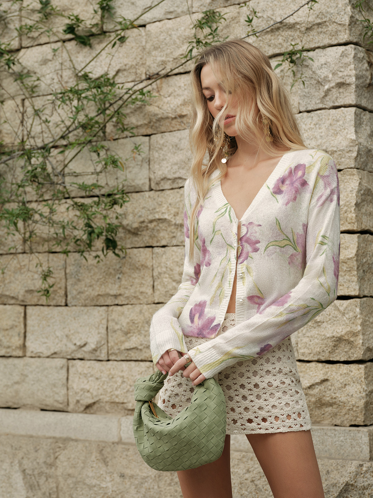 Floral wool-blend knit cardigan with cozy patterns, paired with cream crochet shorts.