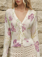 LA FINE FLEUR Floral Wool-Blend Knit Cardigan featuring cozy patterns, paired with a cream lace skirt.