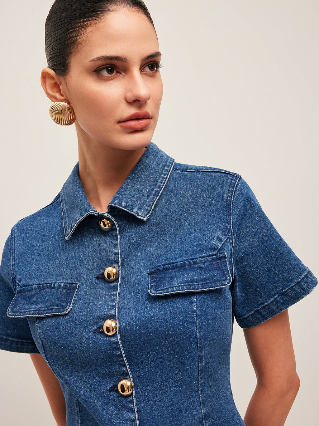 A stylish denim dress with a button-down front and gold buttons from LA FINE FLEUR.