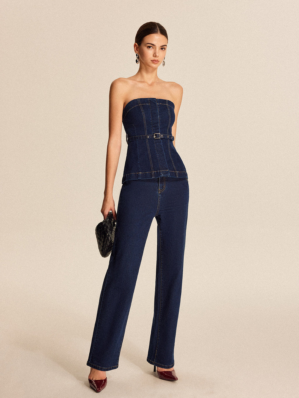 A belted denim strapless top featuring a structured fit and subtle seam detailing throughout.