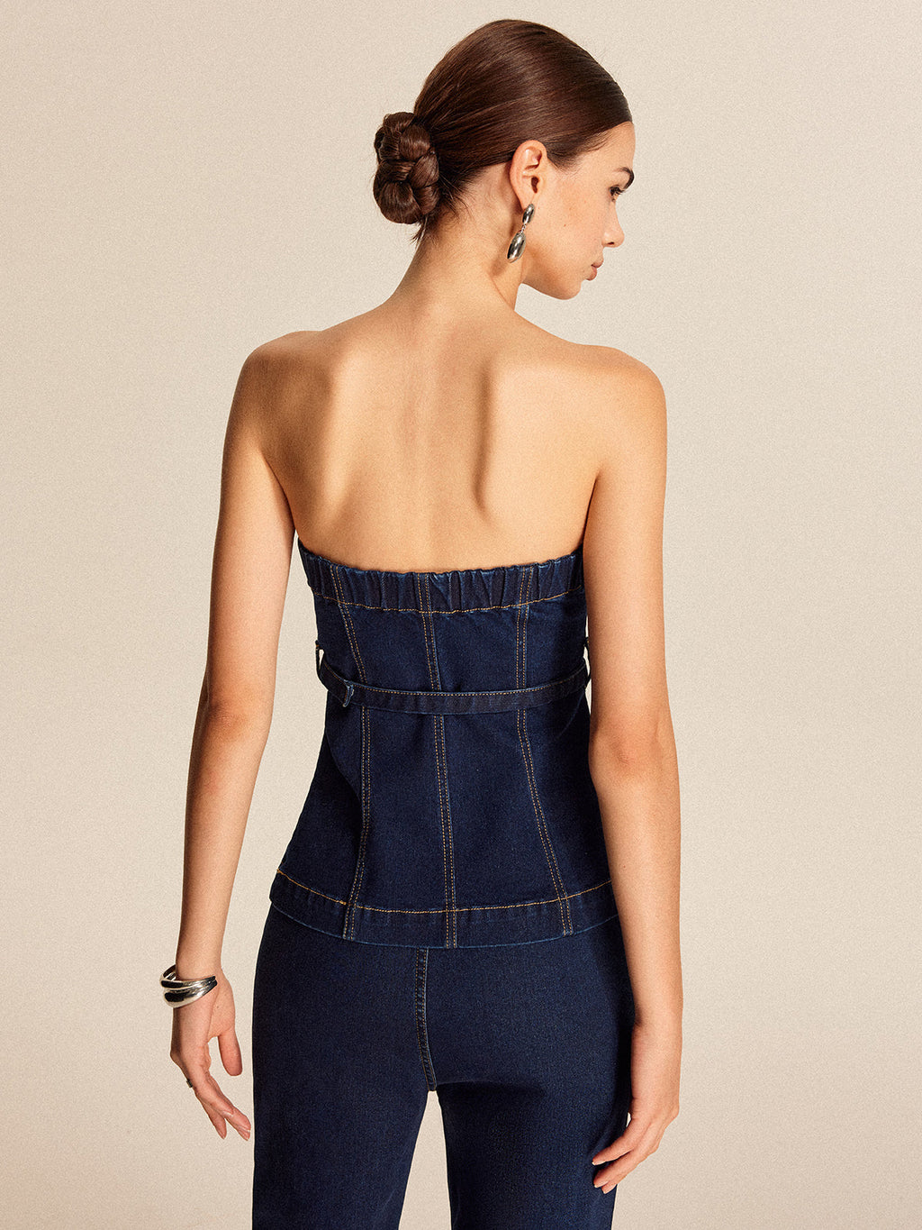 Strapless denim belted top paired with coordinating matching denim pants.