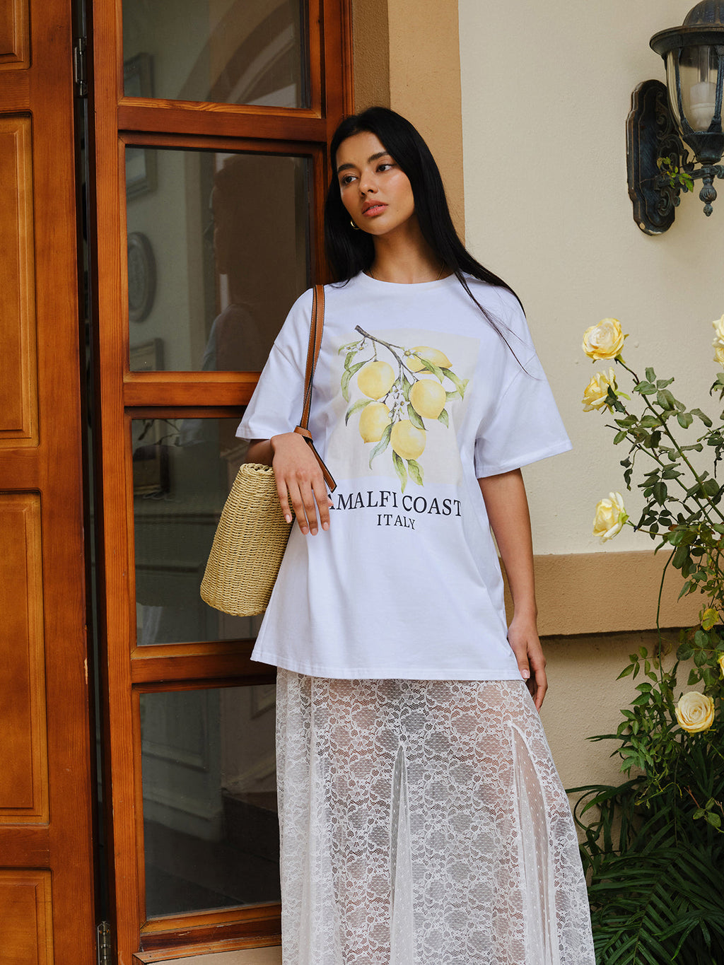 Oversized cotton print tee with lemon motif and Amalfi Coast text, paired with white lace skirt.