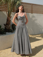 LA FINE FLEUR gingham sleeveless dress featuring a belted waist and classic check pattern.