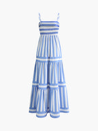 Sleeveless blue and white striped dress with thin straps, smocked bodice, tiers, and pockets.