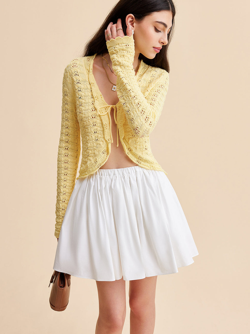 LA FINE FLEUR crocheted cardigan sweater with tie-front, matching top, and white flared skirt.