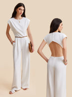 Cap sleeve jumpsuit with wide legs, belted waist, and buttoned dramatic open back.