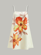Sleeveless A-line dress with thin straps, orange and yellow floral prints on light gray.