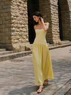 LA FINE FLEUR Cami Sweater Dress with pleated hem detail and white sandals.