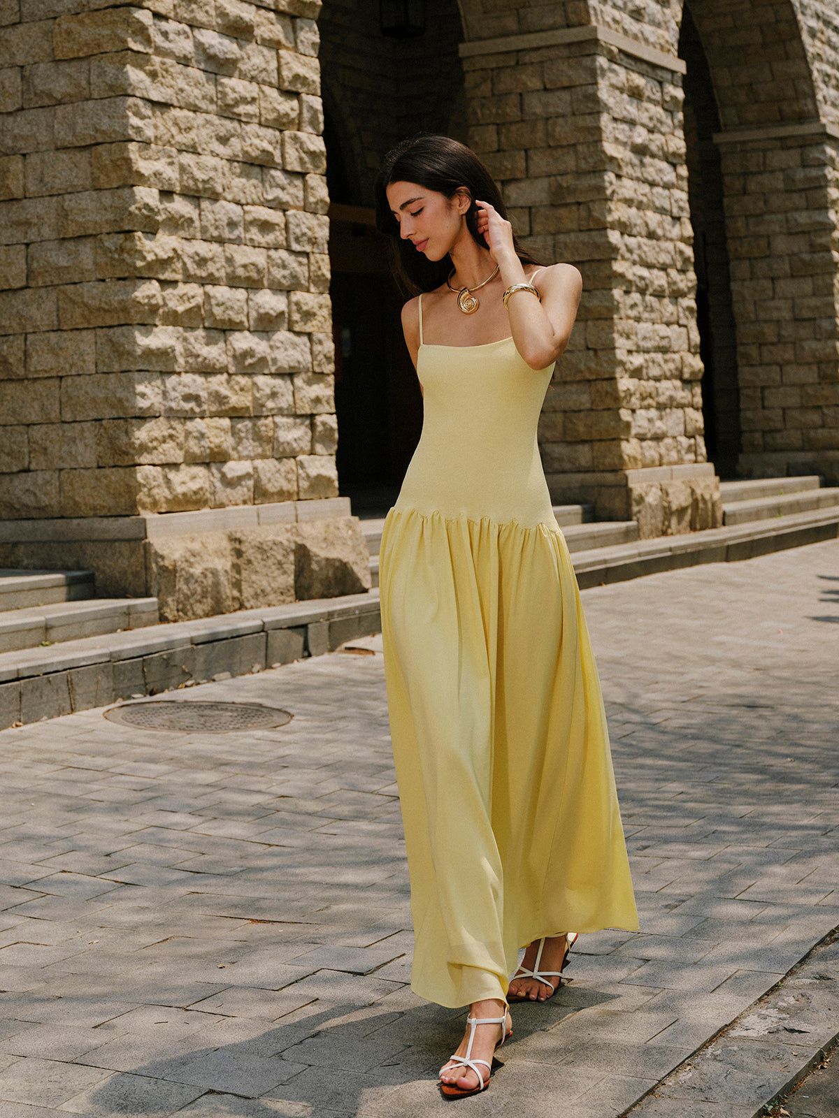 LA FINE FLEUR Cami Sweater Dress with pleated hem detail and white sandals.