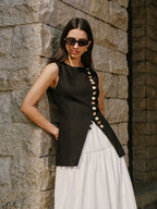 LA FINE FLEUR Linen Vest featuring elegant button details, paired with a classic white skirt.