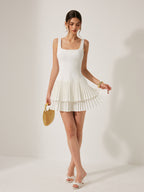 A LA FINE FLEUR square neckline dress with pleated detail and an elegant silhouette.