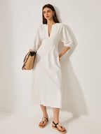 A cotton and linen dress with puff sleeves from LA FINE FLEUR in a light tone.
