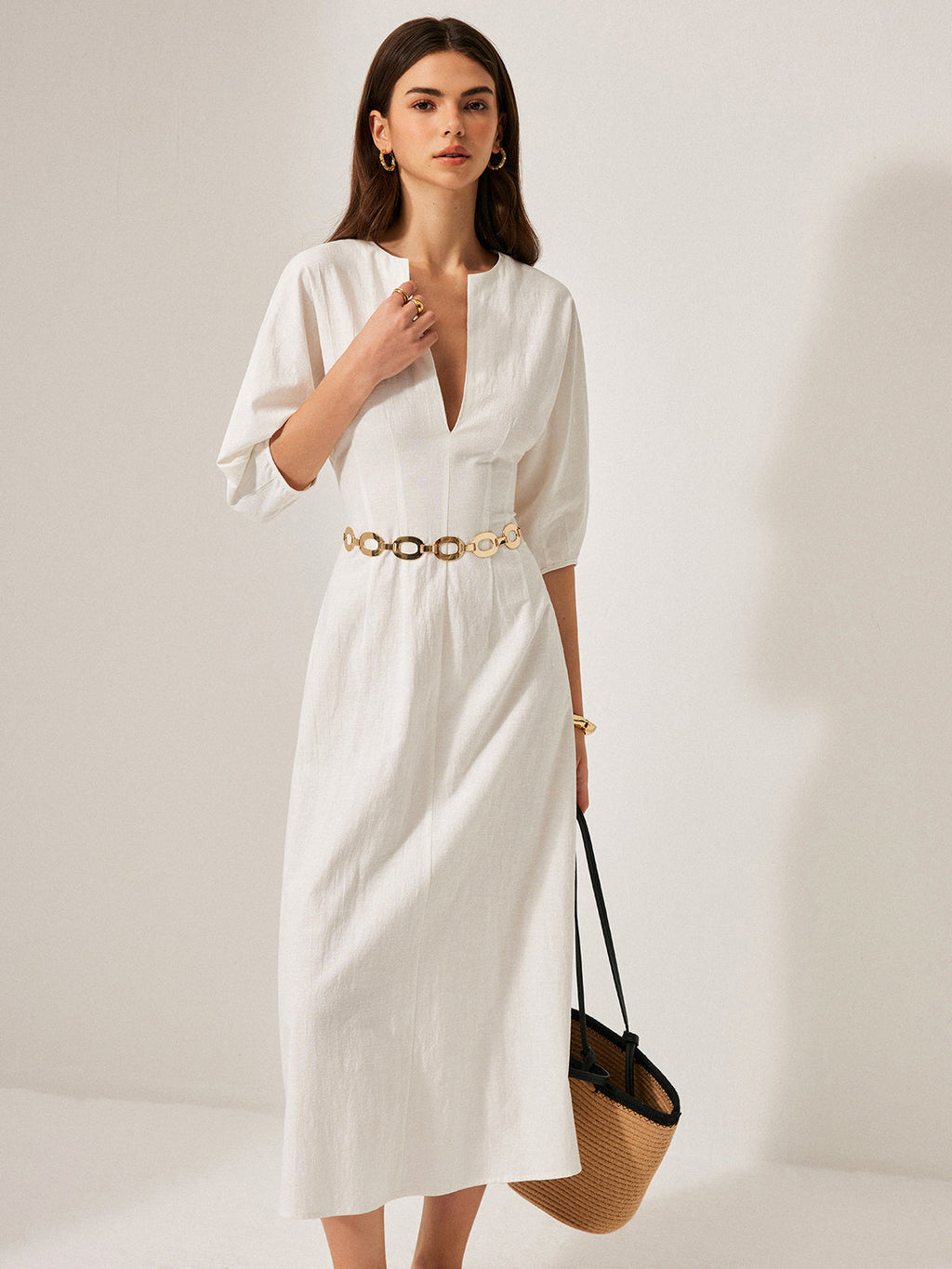 LA FINE FLEUR Cotton and Linen Dress with Puff Sleeves, gold belt, and bracelet.