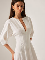 White midi cotton and linen dress with relaxed fit and elbow-length puff sleeves.