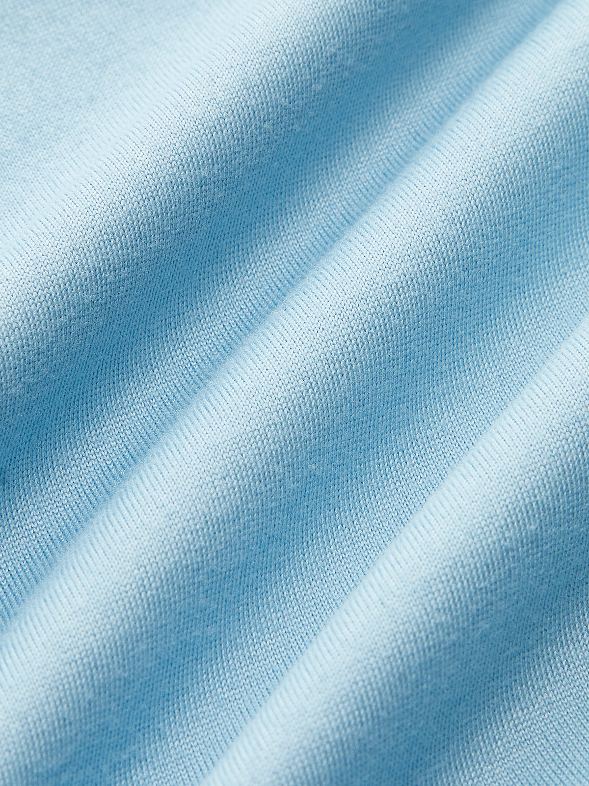 Light blue sleeveless top with knit texture and gentle folds creating soft, subtle shadows.