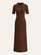 A midi dress with metal buttons, collar, and short sleeves in a relaxed silhouette.