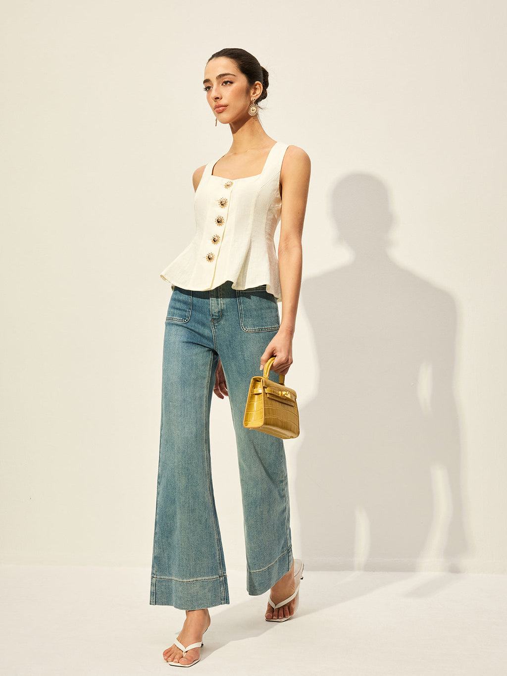 BYPINKYPARIS square neckline buttoned peplum blouse paired with wide-leg blue jeans.