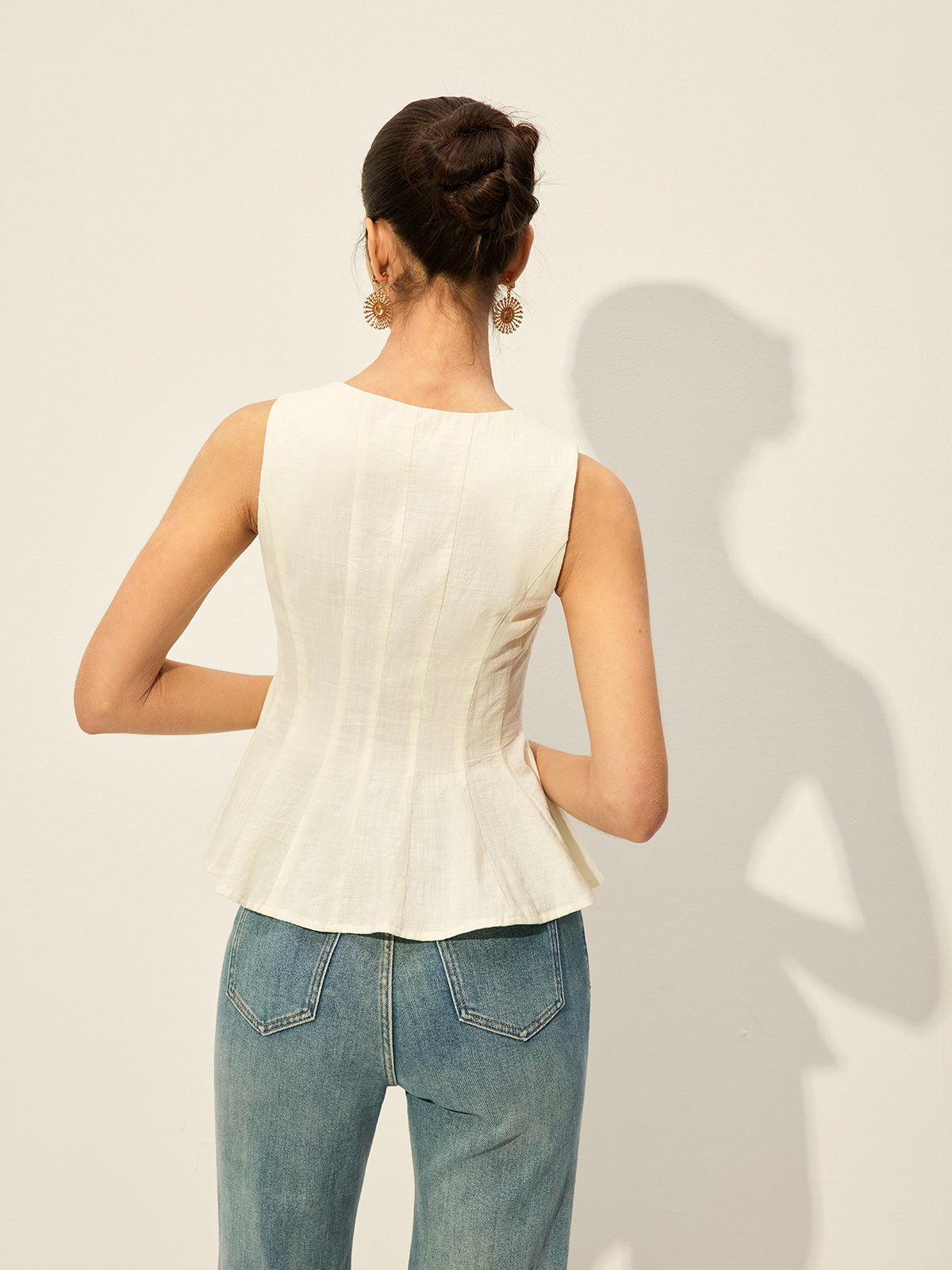 Square neckline buttoned peplum blouse paired with classic blue jeans.