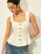 A square neckline buttoned peplum blouse paired with classic blue jeans.