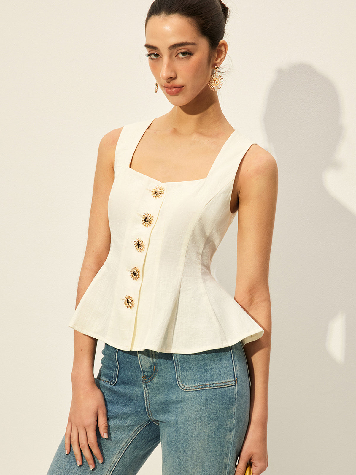 Off-white square neckline buttoned peplum blouse paired with classic blue straight-leg jeans.