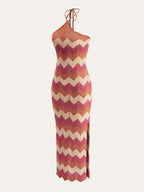 Sleeveless, form-fitting chevron dress in pink, orange, and beige with a side slit.