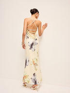 LA FINE FLEUR floral dress featuring a lace-up backless design and delicate fabric.