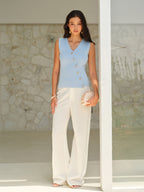 BYPINKYPARIS V-Neck sleeveless top with gold buttons and cream wide-leg pants.