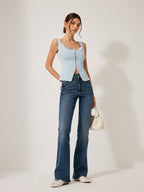 LA FINE FLEUR Lace-Trimmed Button-Front Blouse paired with blue flared jeans and white shoes.