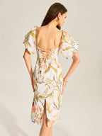 Backless floral dress with puff sleeves, lace-up open back, square neckline, rear slit.