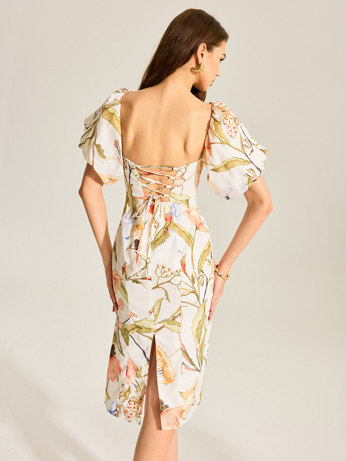 Backless floral dress with puff sleeves, lace-up open back, square neckline, rear slit.