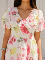 Chiffon mini dress with pink and green floral prints and short puff sleeves.