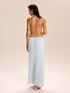 Light blue, textured backless halter top and long flowy skirt with elastic waistband.
