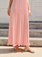 LA FINE FLEUR Spaghetti Strap Pleated Maxi Dress in pink with metallic sandals.