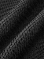 Ribbed knit midi dress with black textured fabric, vertical lines, and soft folds visible.