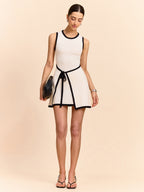 A beige LA FINE FLEUR mini dress with contrast trim and a tied waist.