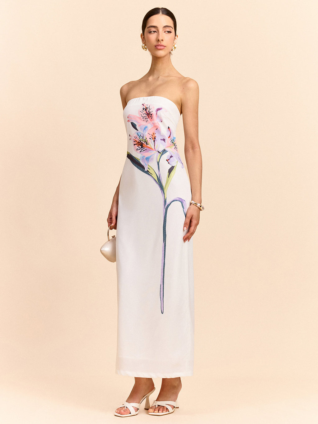 A strapless maxi dress featuring an elegant floral design from LA FINE FLEUR.